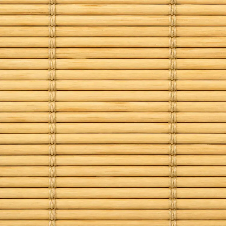 Extreme close-up of a pale honey bamboo blind with repeating strips and binding threads