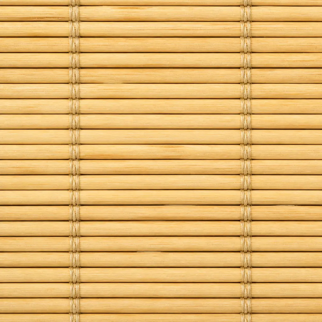 Extreme close-up of a pale honey bamboo blind with repeating strips and binding threads