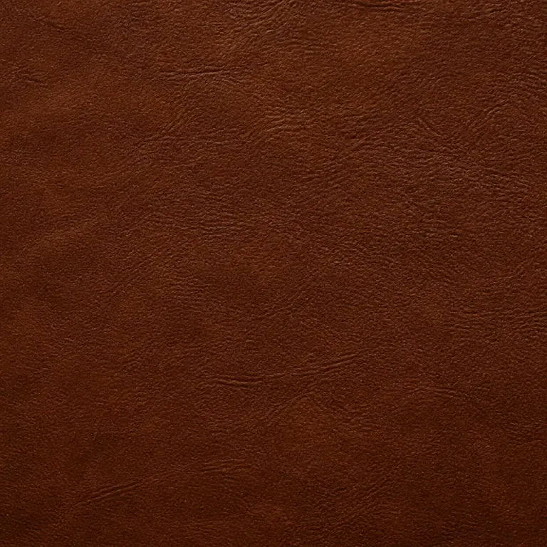 Warm chestnut matte leather grain with natural wrinkles in low raking light