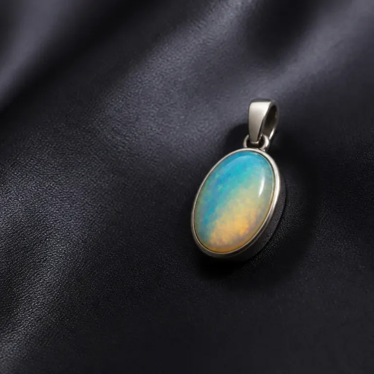 Oval opal pendant with teal and amber play-of-color on dark charcoal silk