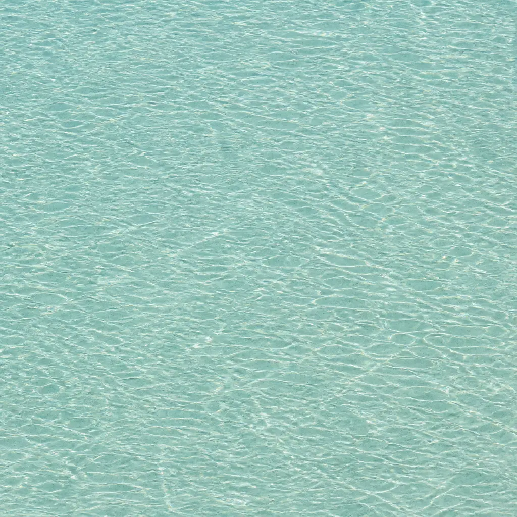 Even overhead texture of pale rippled water with sparse fine mineral particles and seamless edges
